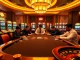 Intense poker game at a luxurious S8-themed casino with vibrant slot machines and professional players.